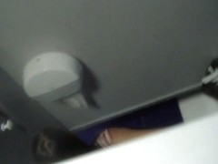 A brunette peeing in the common bathroom