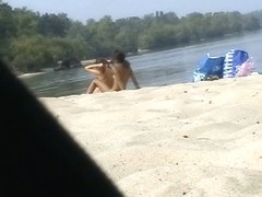 Cute lesbian teens enjoying sunbathing at nudist beach