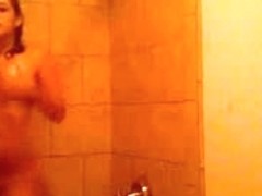 Attractive brunette girl dancing in the shower