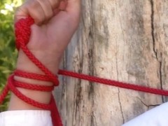 Big tittied babe is tied up by red ropes