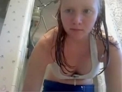 Redhead girl shaves her pussy under the shower