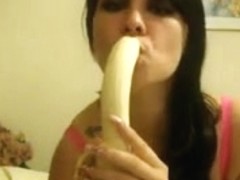 Teen brunette sucks a banana on cam