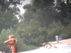 Nudist girls and guys are having good time in beach