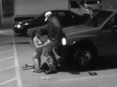 Babe is on knees sucking cock in the parking place in voyeur xxx