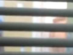 Lovely girl gets filmed trough the window on a spy camera