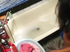 Voyeur tapes a hot girl playing with herself in the bathtub