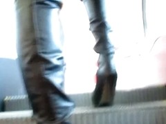 Girl in black leather boots and tan stockings on escalator