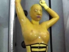 Hot girl in latex glamour yellow catsuit gets to climax