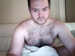 Juicy male is having fun in the guest room and filming himself on webcam