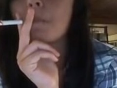 Cute and sexy teen babe smokes a cigarette